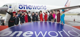 Representative cabin crew of the oneworld member airlines pose in front of TAM airlines A320