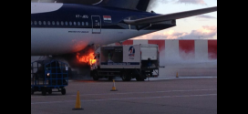 A cleaning truck on fire just below Jet Airways Boeing 777-300ER VT-JEQ at London Heathrow airport