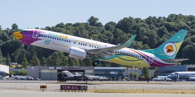 10th anniversary livery Nok Air 737-800 registration HS-DBO takes off from Seattle. Boeing image.