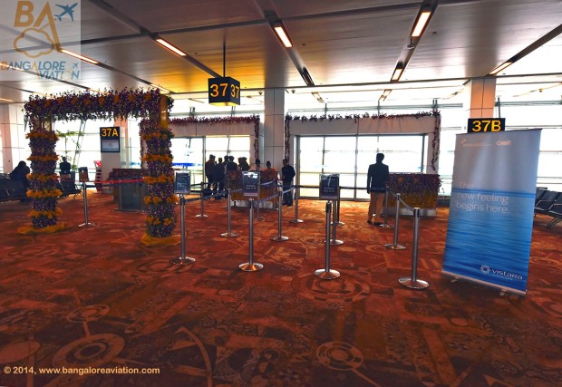 Vistara (Tata-SIA airline) inaugural flight UK890 New Delhi to Mumbai. Boarding gate 37, decorated with orchids in the corporate purple colour.