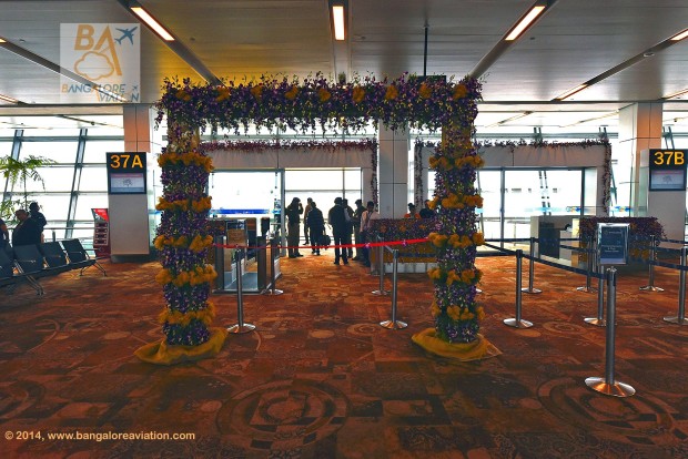 Vistara (Tata-SIA airline) inaugural flight UK890 New Delhi to Mumbai. Boarding gate 37, decorated with orchids in the corporate purple colour.