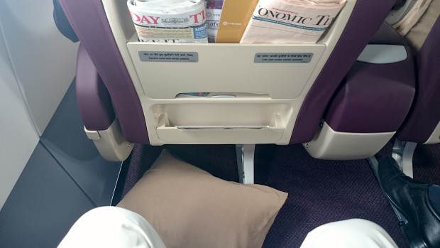 Vistara A320 business class seat. Leg room and news papers.