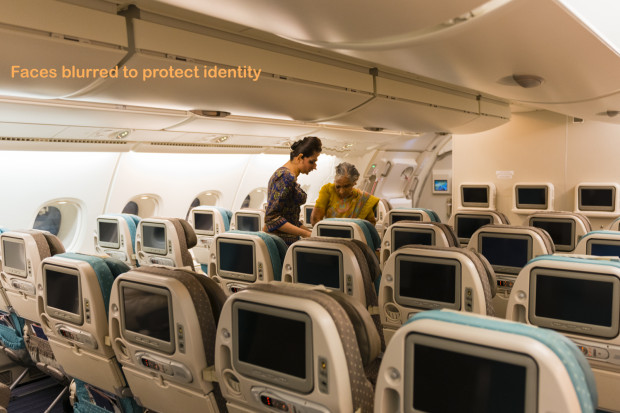 Singapore Cabin Crew Helping Passenger