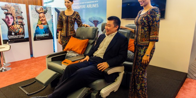 Singapore Airline's India country head David Lau demonstrates the new premium economy seat