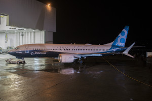 The new 737 MAX 8 rolls out of the paint hangar in Renton.