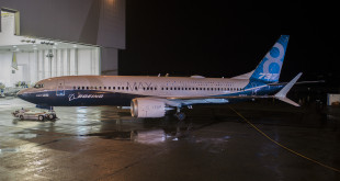 The new 737 MAX 8 rolls out of the paint hangar in Renton.