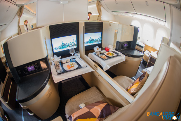 A close up of a pair forward center seats. Business class cabin on Etihad's Boeing 787-9.