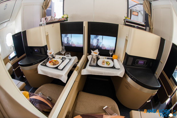 A close up of a pair forward center seats. Business class cabin on Etihad's Boeing 787-9.