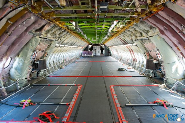 From the rear of the aircraft looking forward, the giant size of the A380 is seen. The conference table and cabin demonstration area is seen in the background.