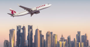 A CGI of a Qatar 737 MAX set against a skyline of Doha's financial center. Boeing Image.