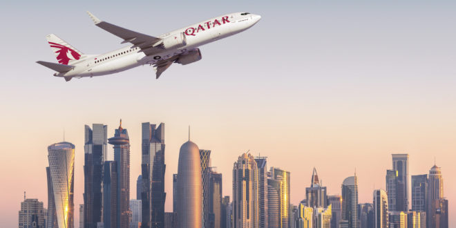 A CGI of a Qatar 737 MAX set against a skyline of Doha's financial center. Boeing Image.