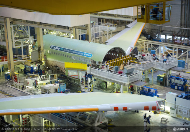 Wings of the first A330neo being joint to the center fuselage at station 40. Airbus Image.